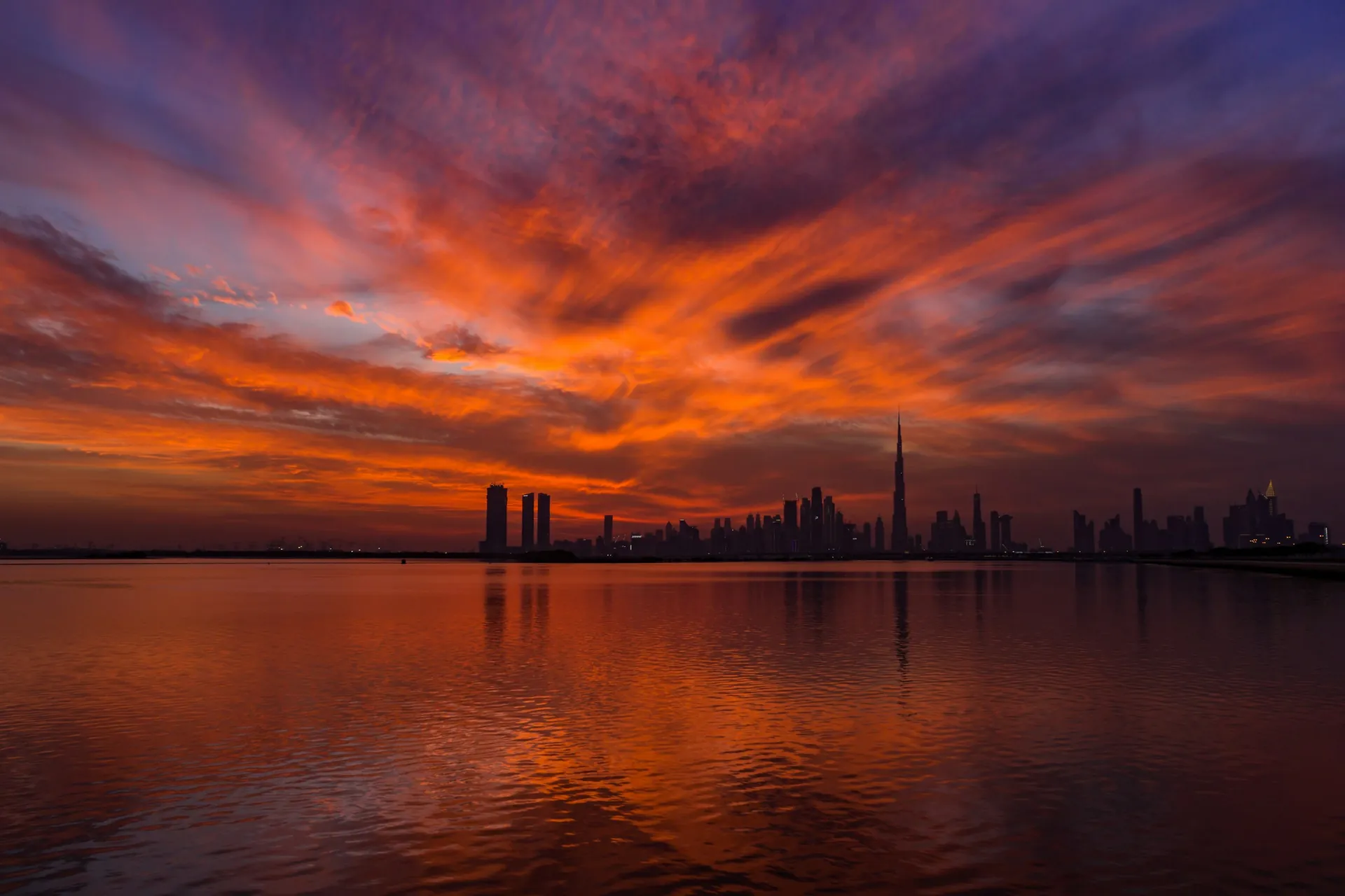 The Dubai skyline across the water at sunset